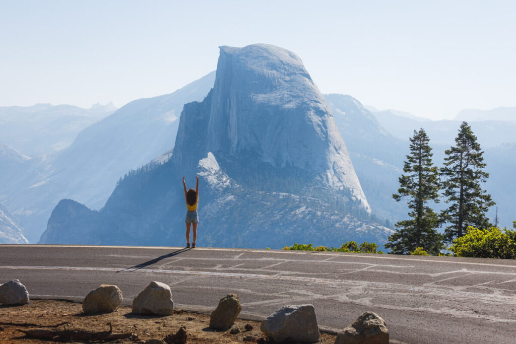 Woman at Glacier Point view with Half Dome in the back.