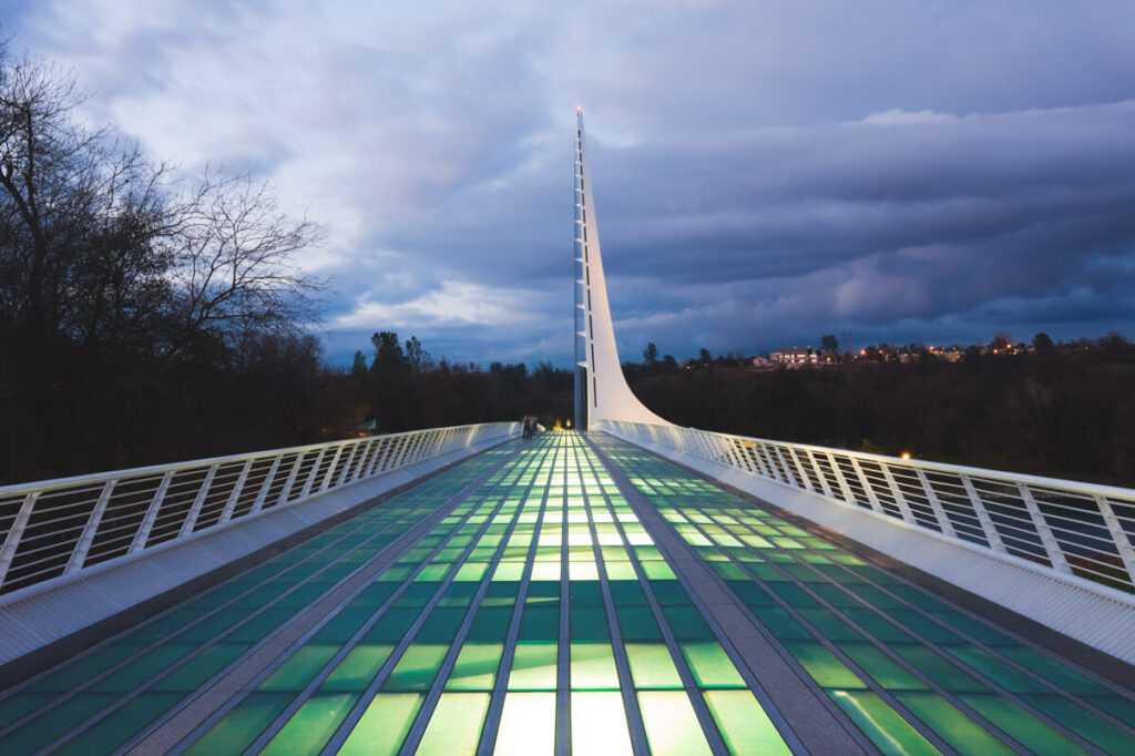 An empty Sundial Bridge in the town of redding lit up at blue hour.