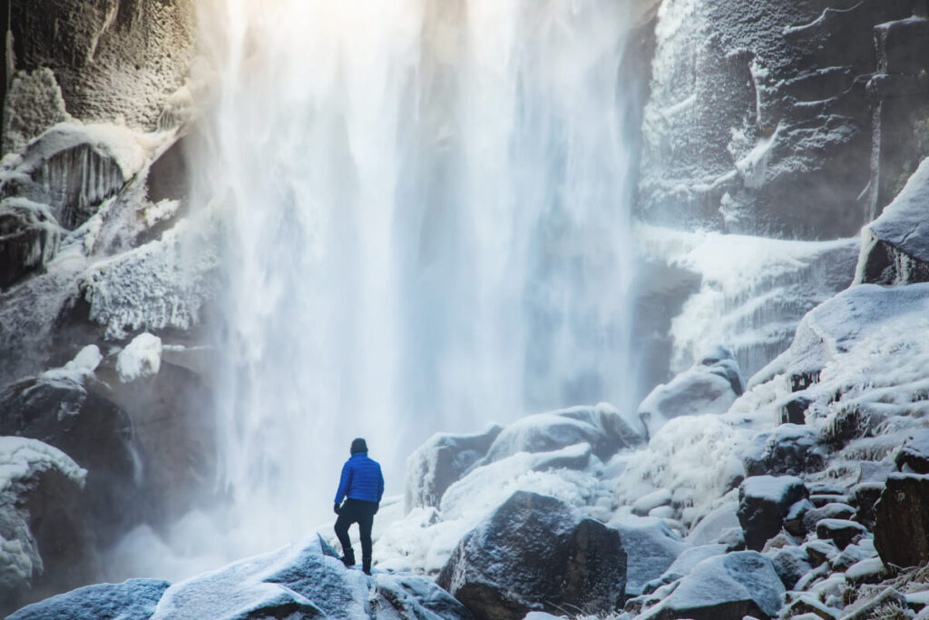 Man at waterfall in winter one of the best things to do in Yosemite