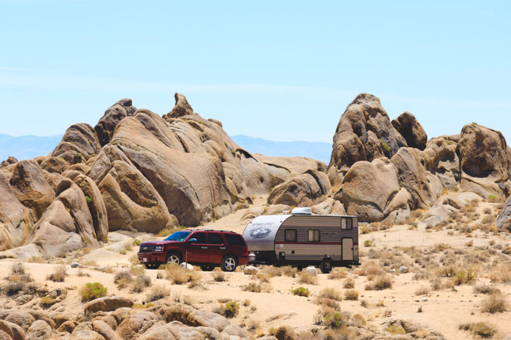 Car towing caravan for camping on the Alabama Hills Movie Road