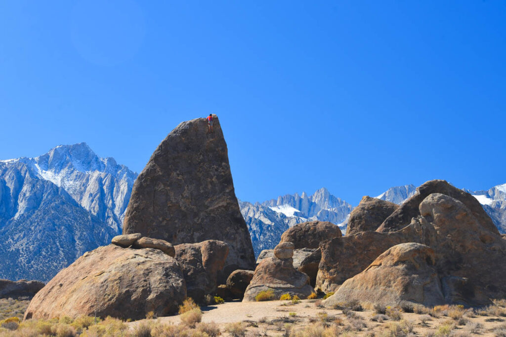 Man climbs rocks at Alabama Hills Movie Road.