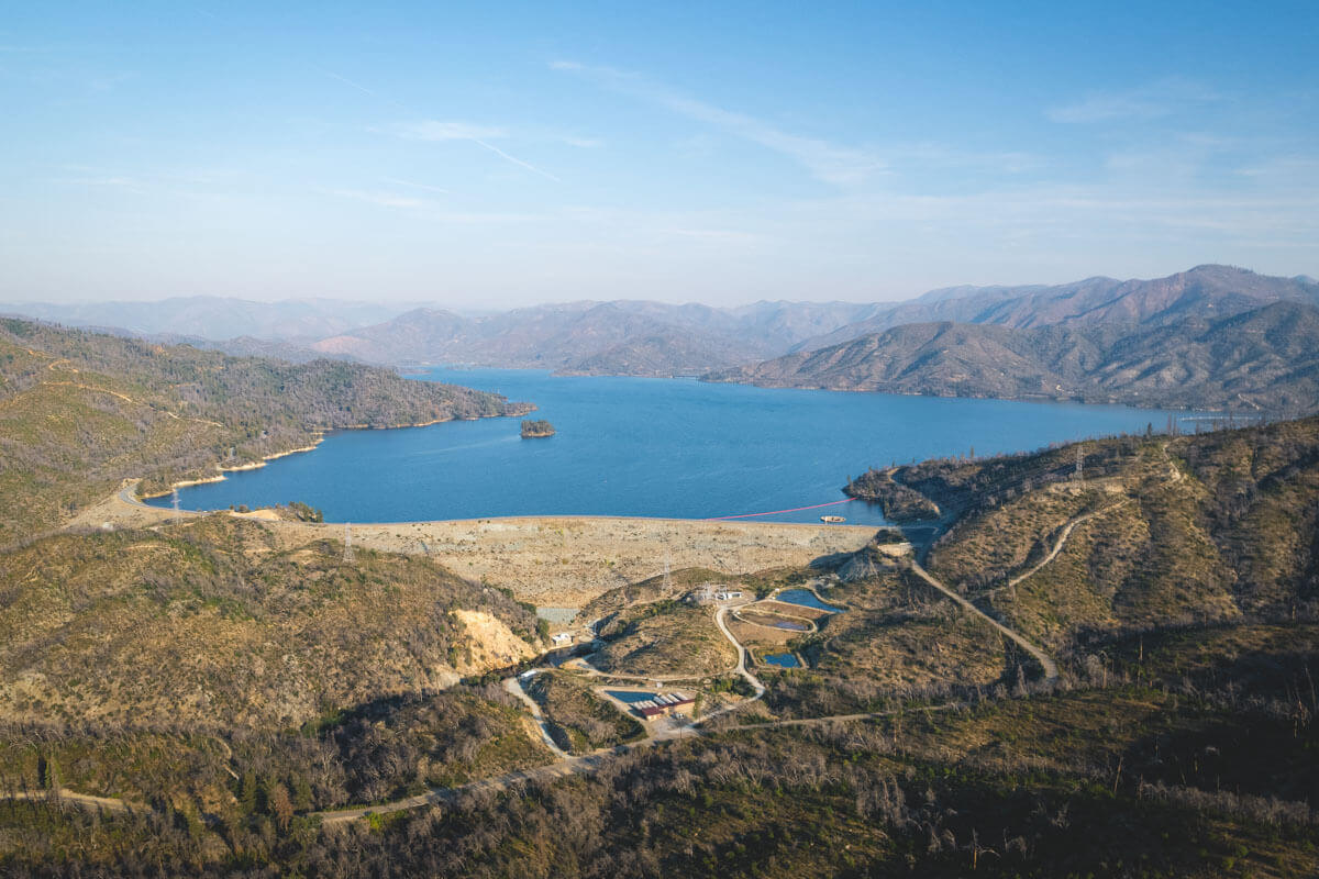 An aerial view over a huge lake in the middle of the hills of Whiskeytown National Recreation Area.
