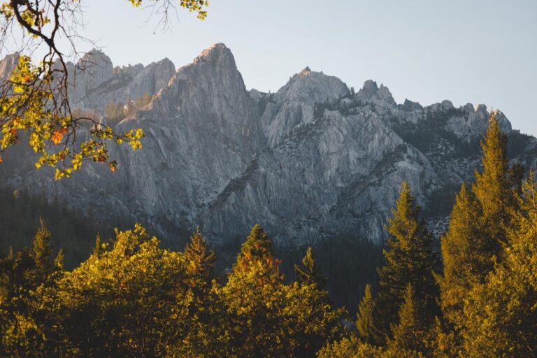 Castle Crags rock formations framed by fall-colored trees.