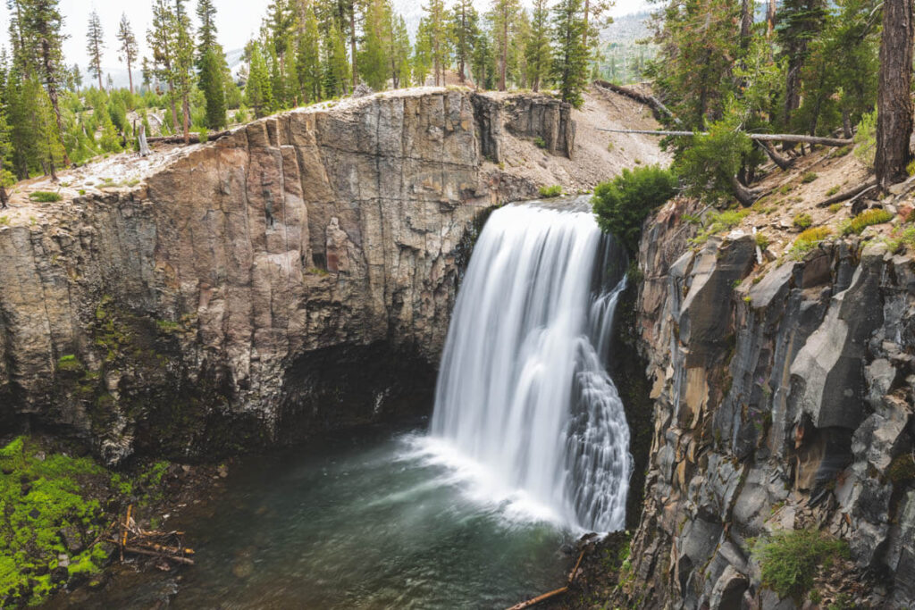 The huge rainbow falls surrounded by rocky cliff faces in Devils Postpile National Monument.