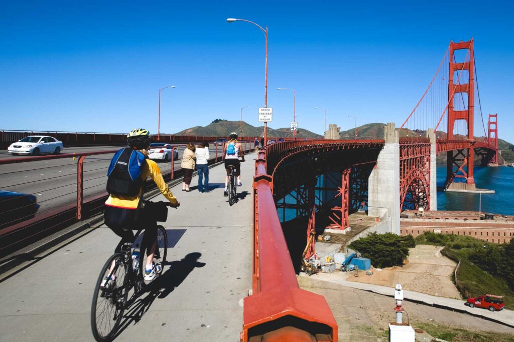 Two bike riders entering the pathway across the Golden Gate Bridge in San Francisco.