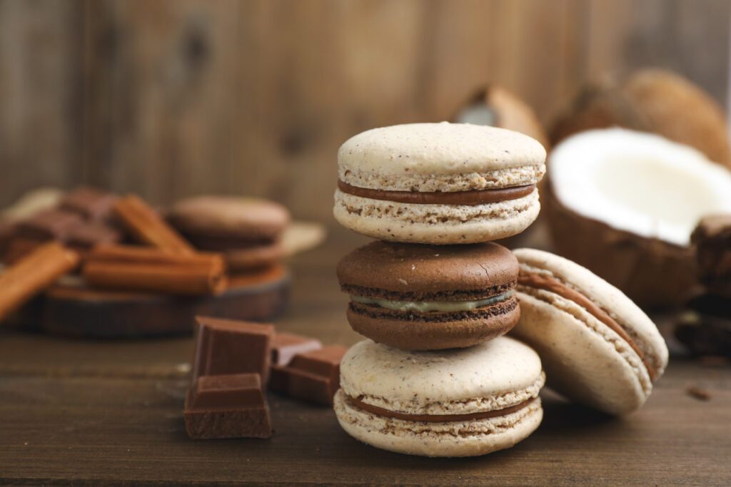 Vanilla and chocolate fresh-baked macarons piled on top of each other.