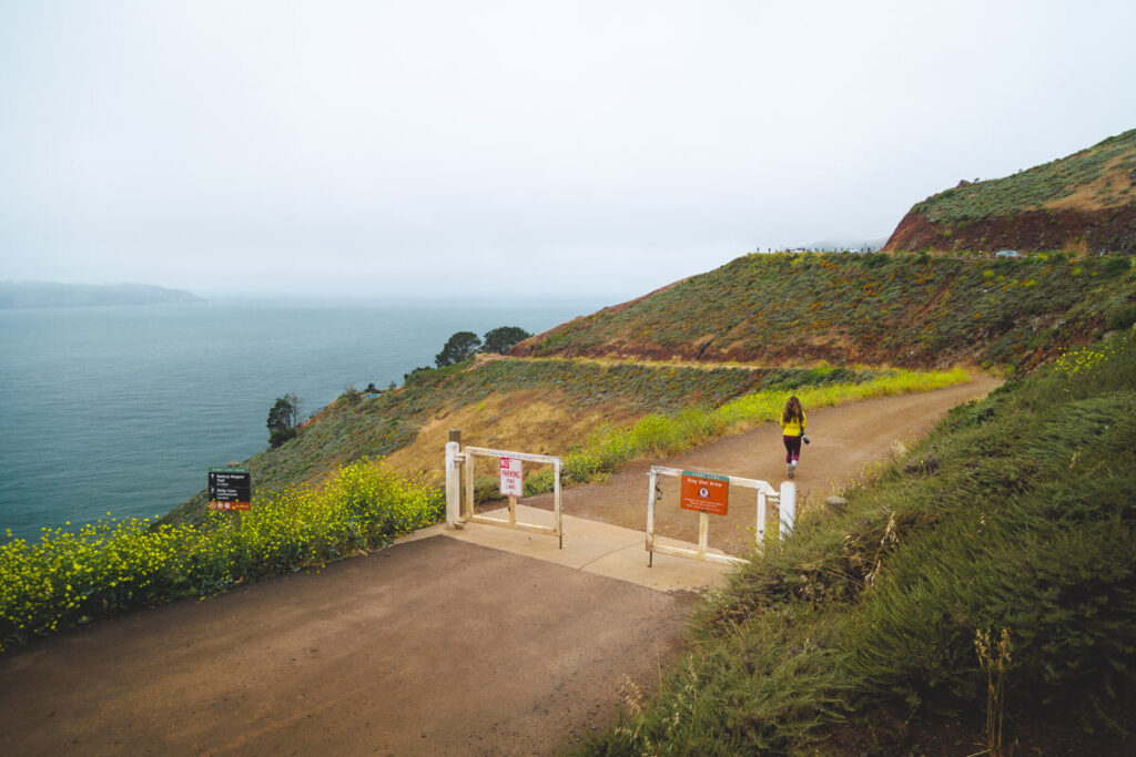 A female hiker at the Kirby Cove trailhead in San Francisco.