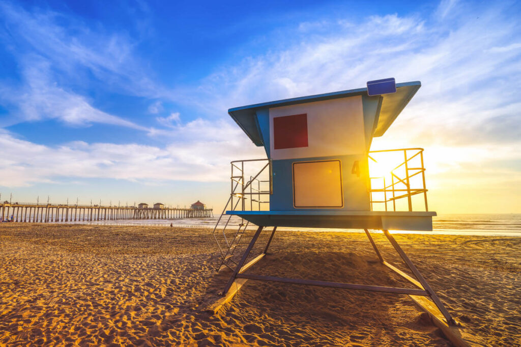 A golden sunset behind a lifeguard hut on Huntington State Beach.