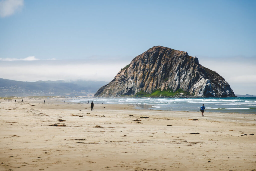 Morro Rock on a sunny day at Morro Rock Strand State Beach in California.