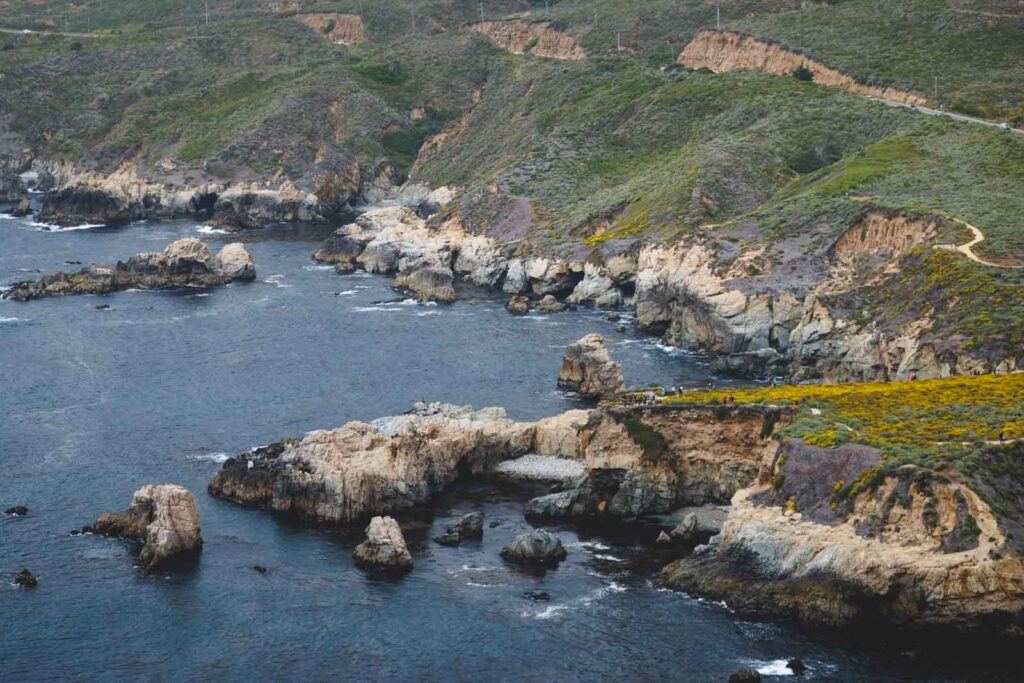 A viewpoint overlooking the ocean and tourists from Whaler's Peak.