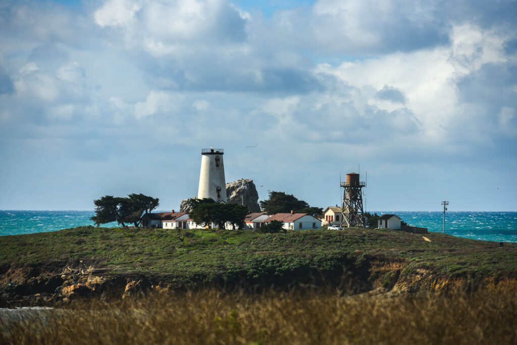 A tall lighthouse surrounded by building in Piedra Blancas Light Station.