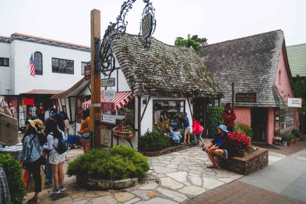Groups of tourists exploring the fairytale looking Court of the Golden Bough in Carmel-by-the-Sea.