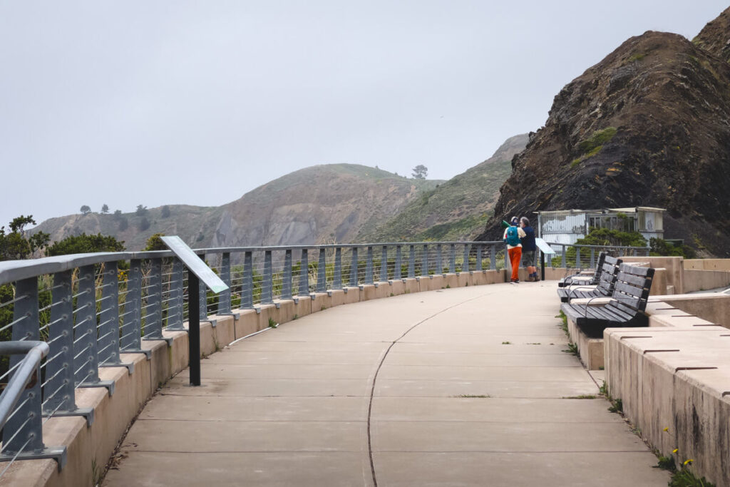 Tourists standing at the viewpoint on the Devil's Slide Trail.