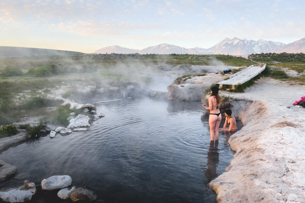 Two female tourists enjoying their morning bathing in the hot springs.