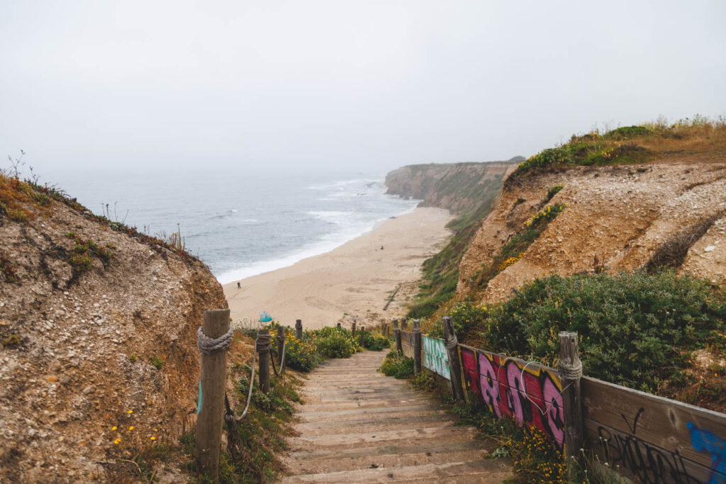 Stairs leading down to Cowell Beach on an overcast Half Moon Bay day.