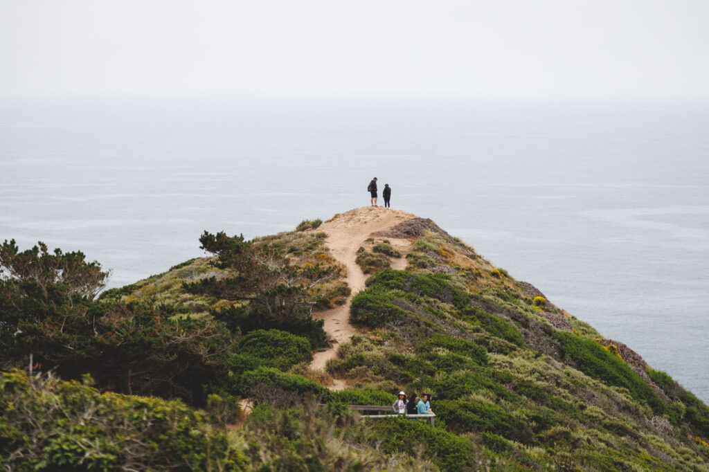 Tourists standing on Whale Peak in Garrapata State Park.