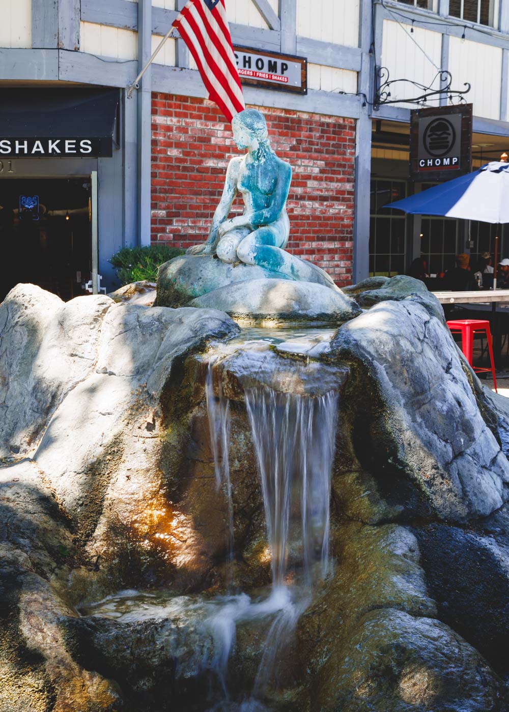 Mermaid statue sat on top of a fountain along a road in Solvang.
