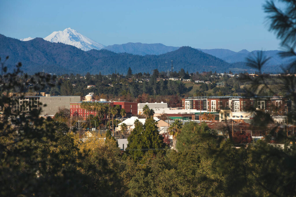 A view over downtown Redding and onward to a mountain range in the distance.