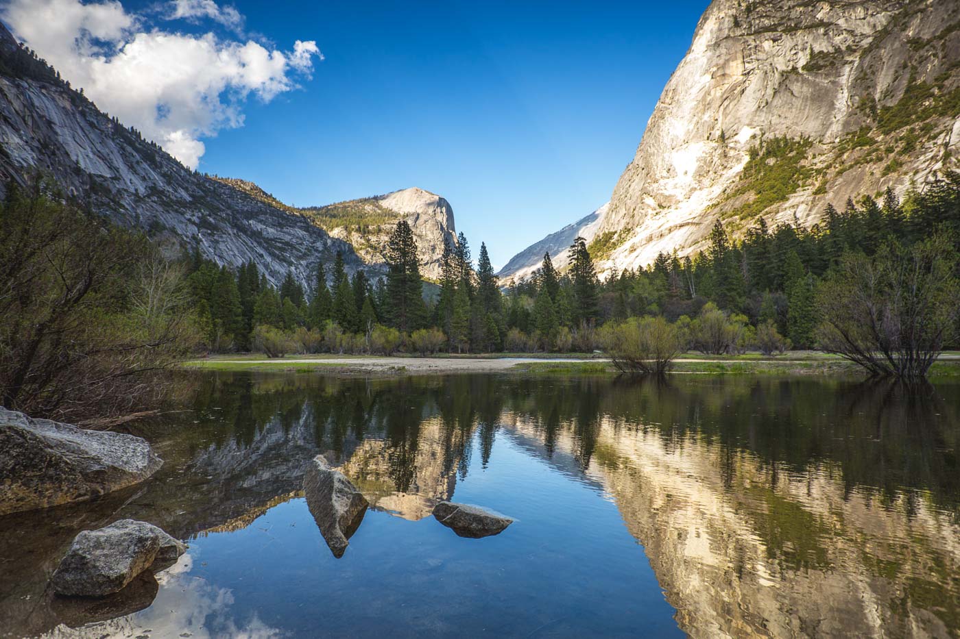 Reflections of Yosemite's mountain in Mirror Lake on a sunny day.