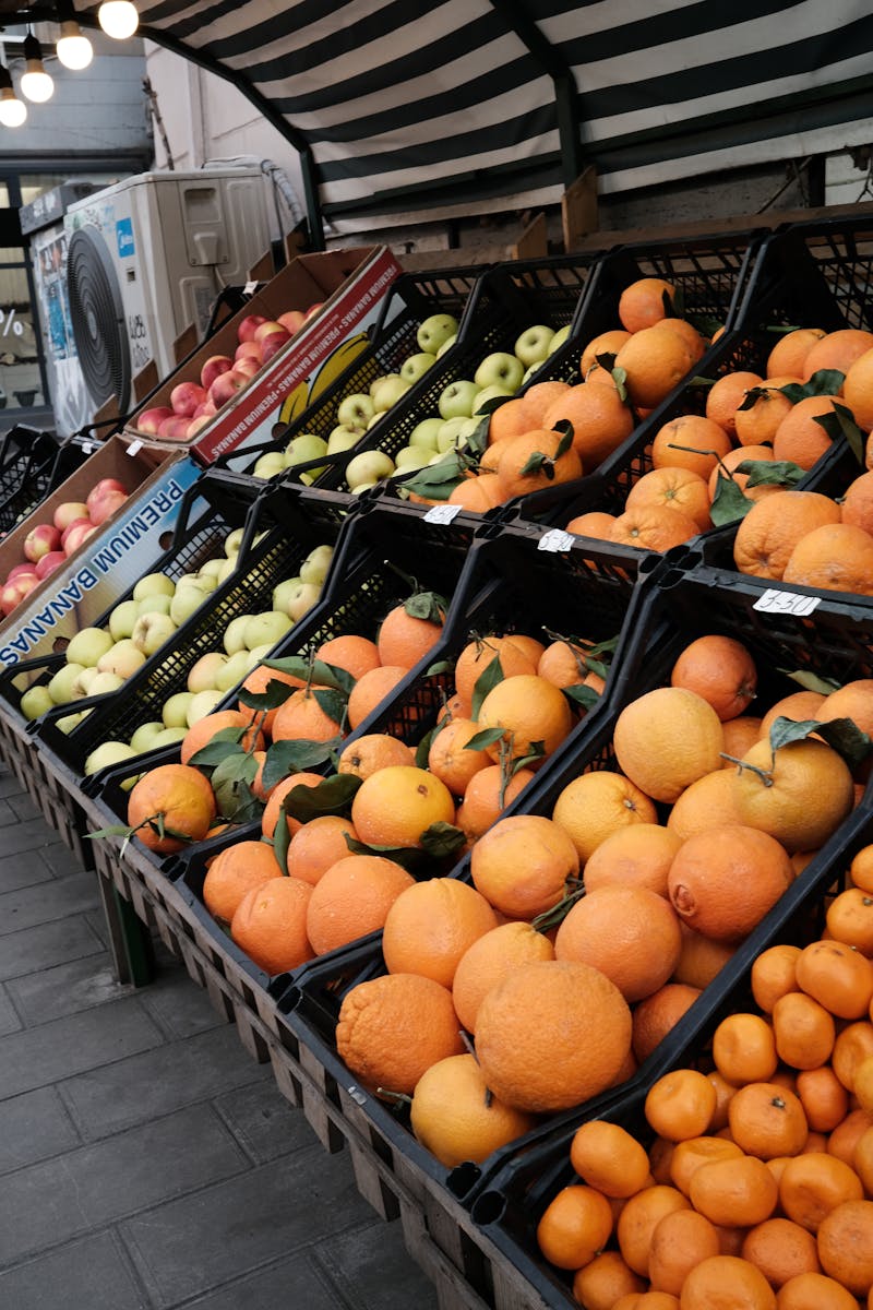 Fresh oranges and apples on display at an outdoor market stall in Tbilisi, Georgia.