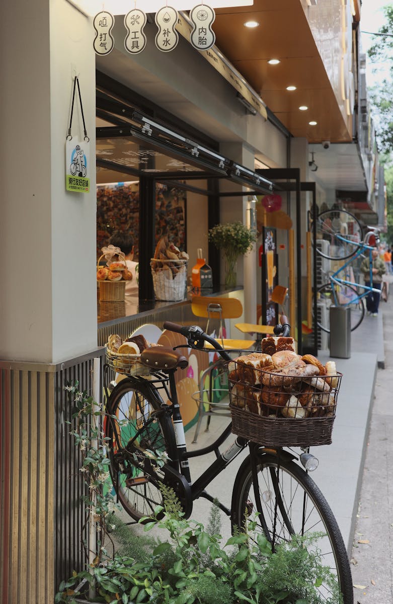 Outdoor urban bakery with bread-laden bicycle in city setting. Cozy and inviting.
