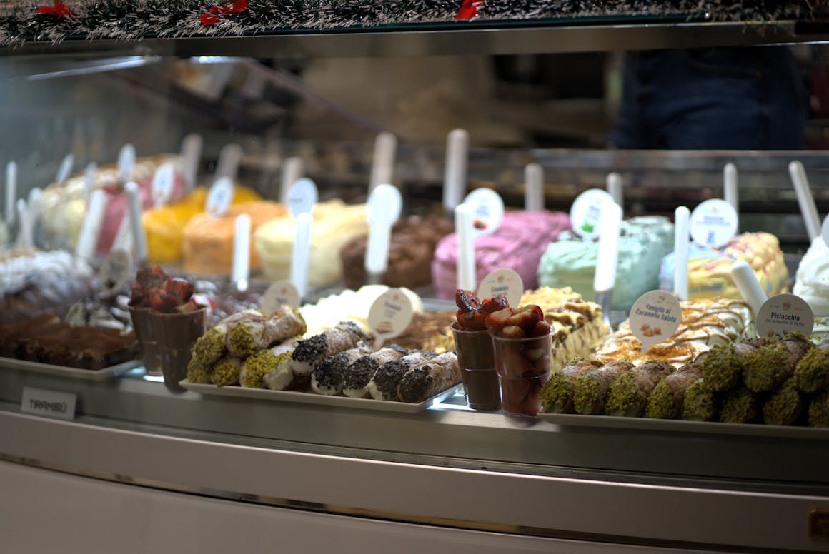 Colorful ice cream and desserts display in a gelato shop in Florence, Italy.