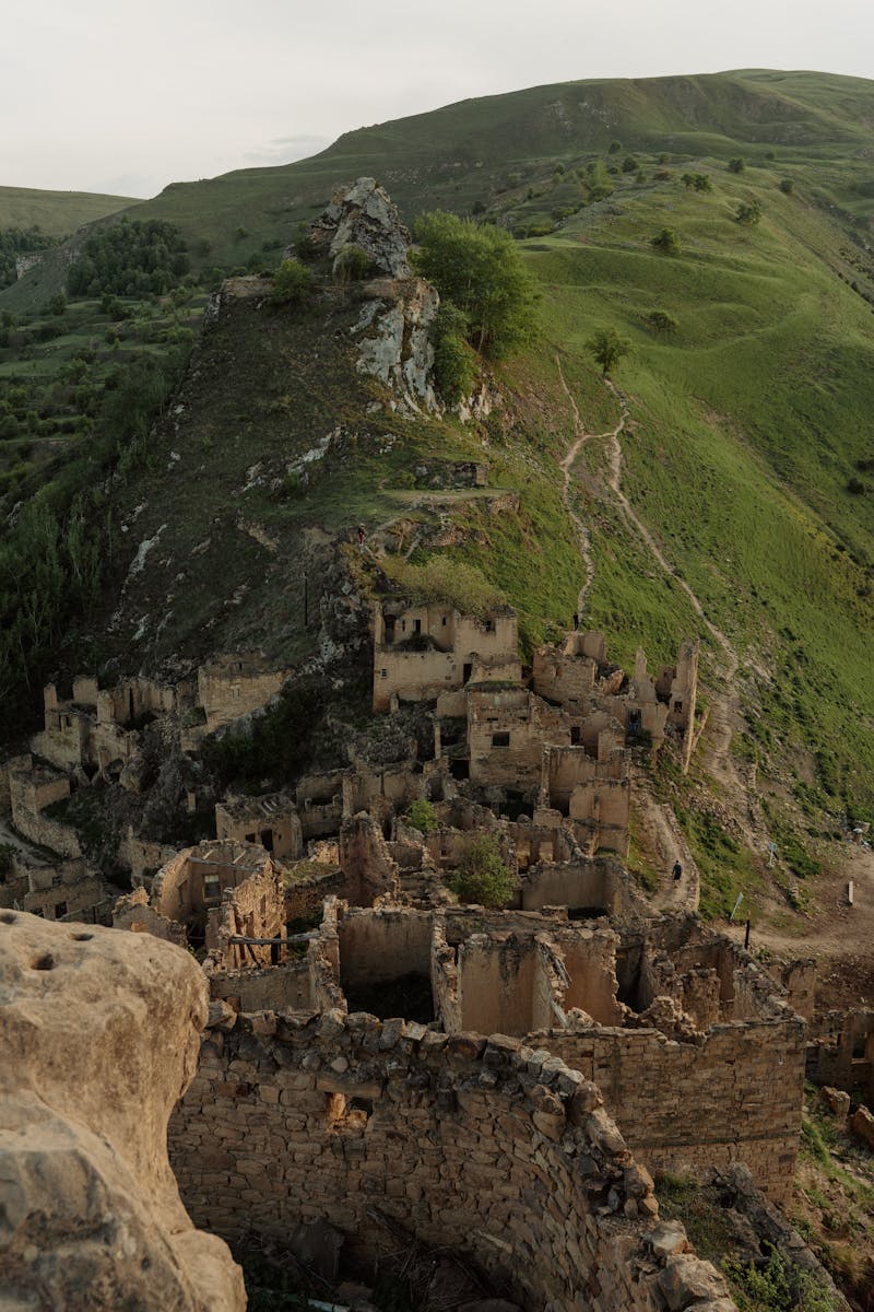 Discover the ancient fortress ruins surrounded by lush mountains and scenic trails, perfect for adventurers.