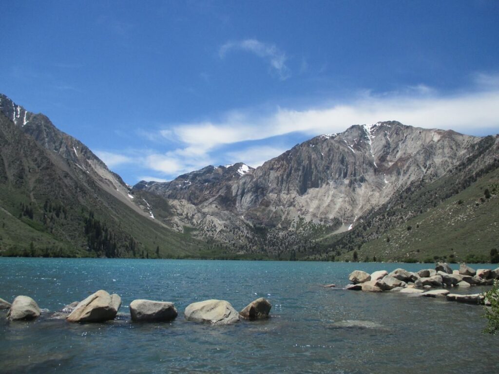 Stunning landscape of Convict Lake with mountains and clear blue water under a vibrant sky.